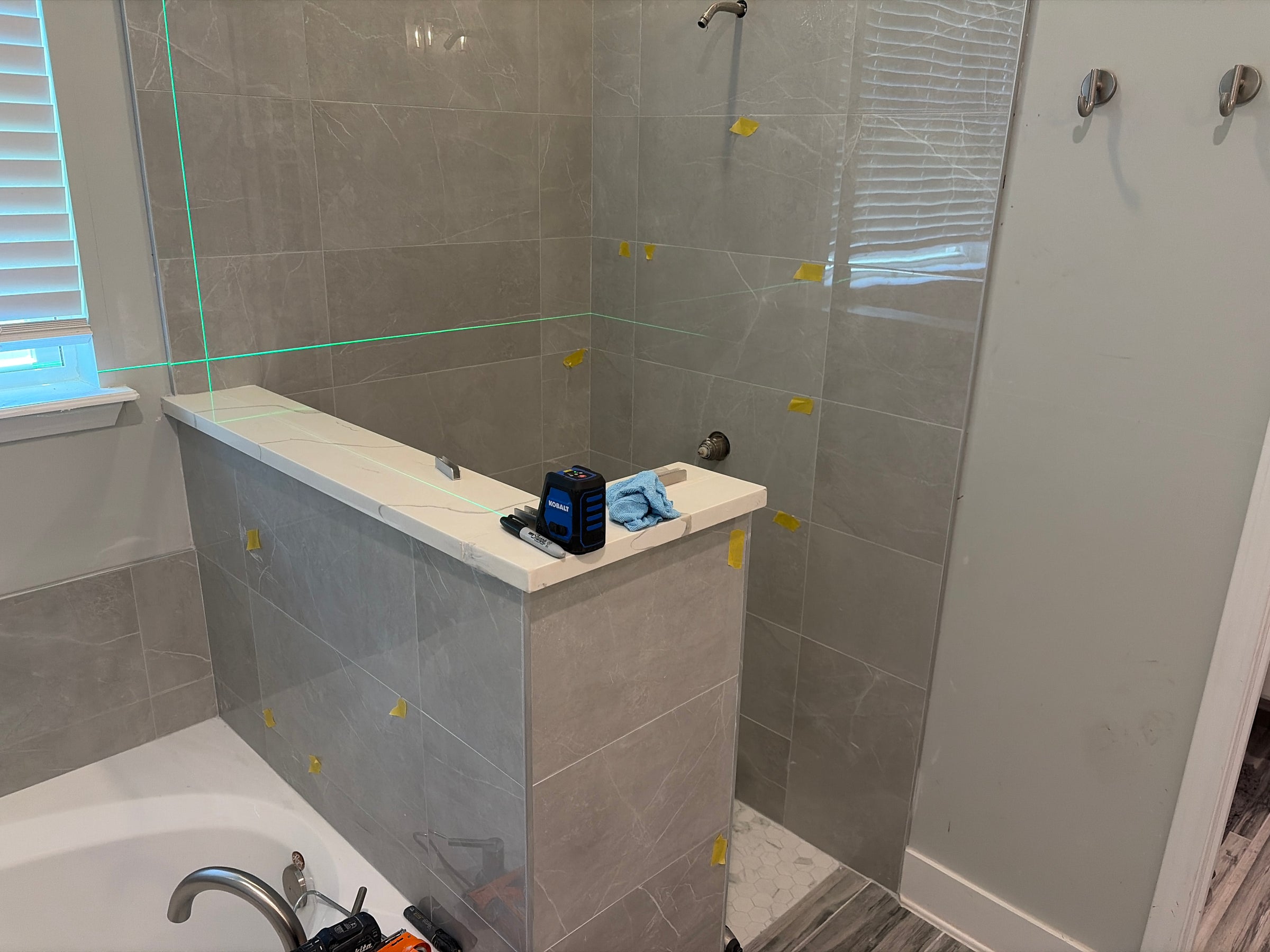 Walk in Yulee shower with glass windows and detached tub.